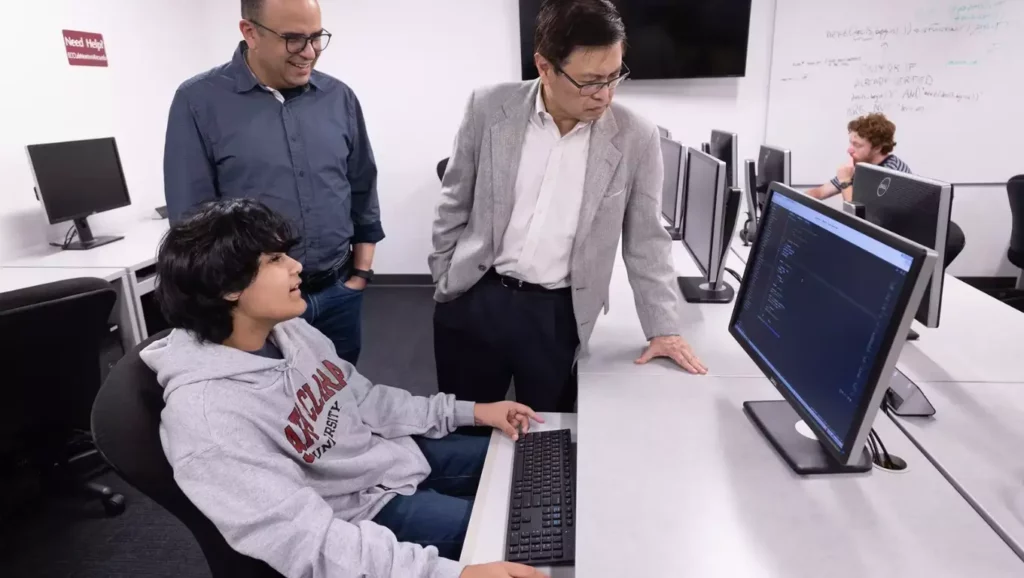 Kairan Quazi, a 14-year-old prodigy, working on a computer alongside his mentors at SpaceX.