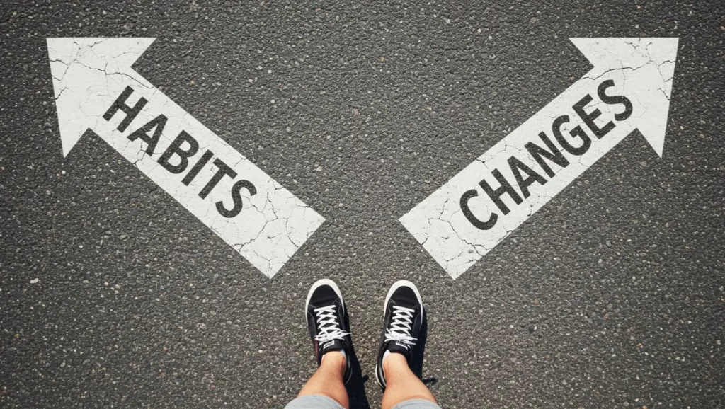 Pieds en face de deux flèches tracées au sol indiquant “Habits” et “Changes”, symbolisant le choix entre habitude et changement.
