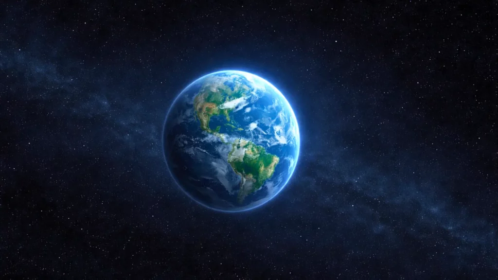 Vue de la planète Terre depuis l’espace, entourée d’étoiles, illustrant la question de l’unicité de la vie dans l’Univers.